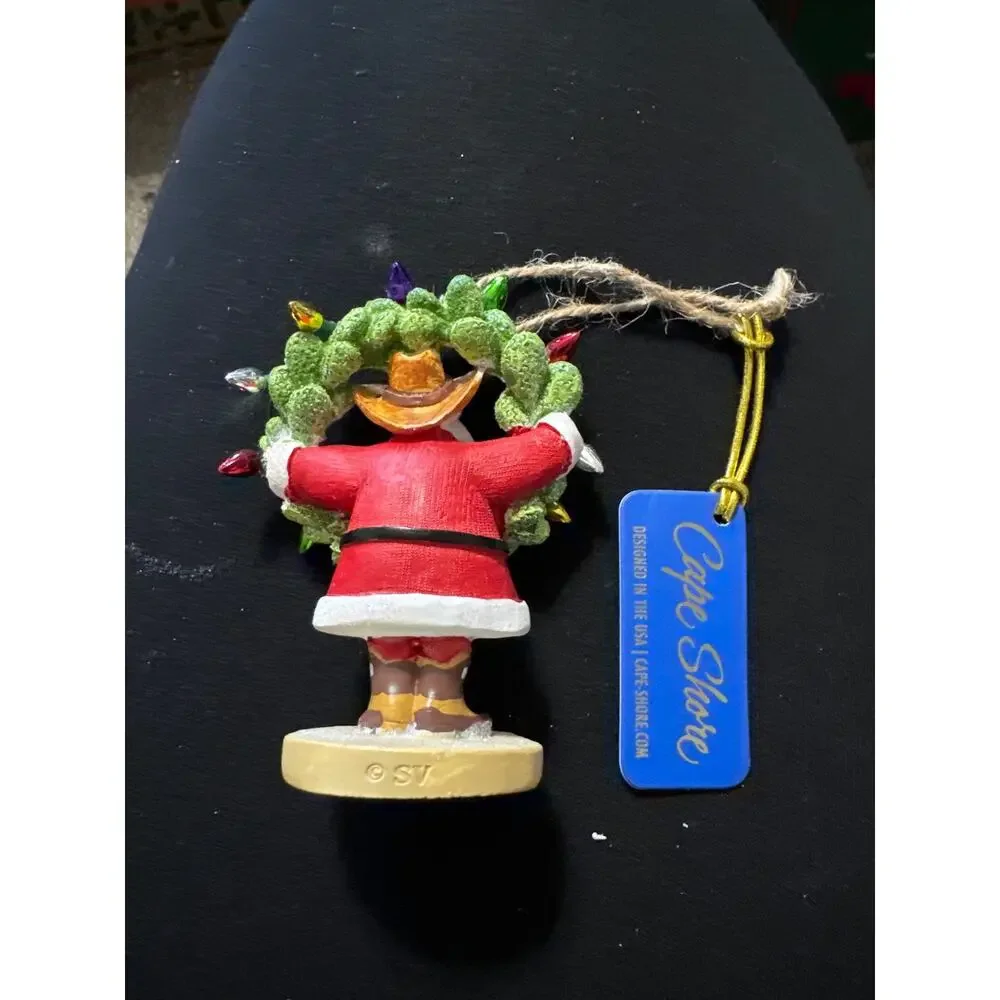 Cowboy Santa‎ with cactus wreath with lights.